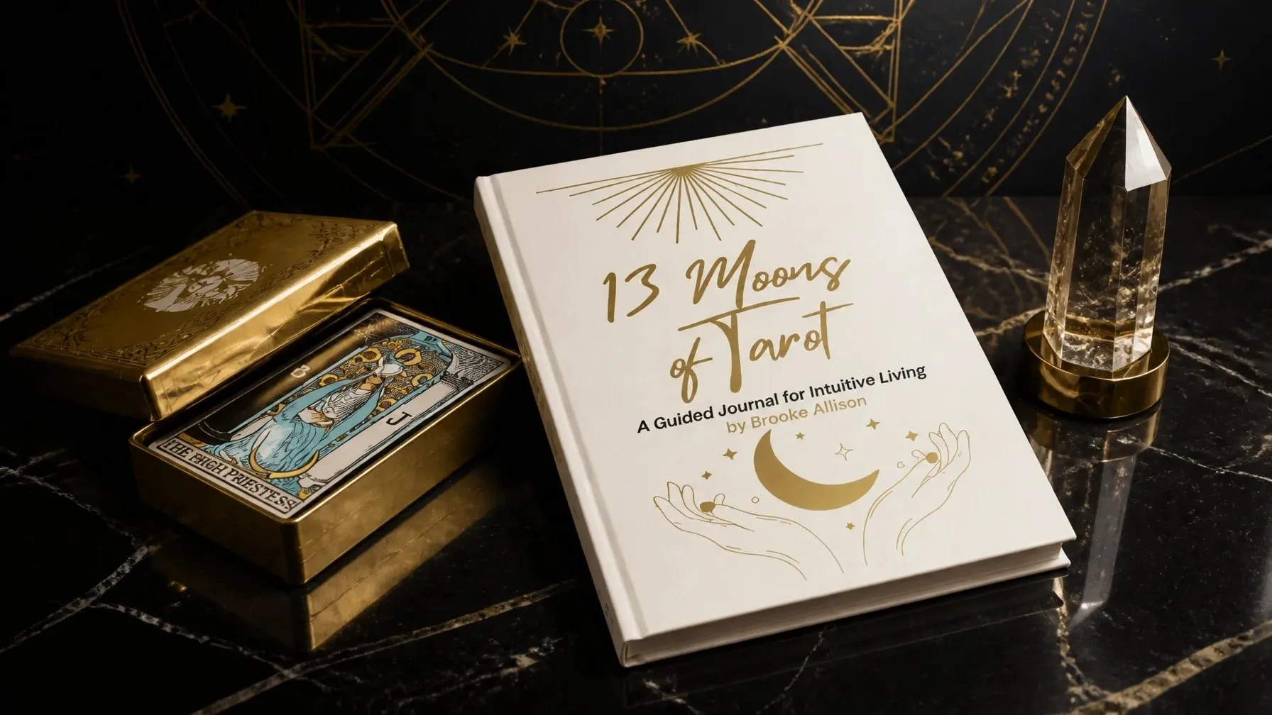 The 13 Moons of Tarot guided journal beside a clear crystal on a dark marble surface
